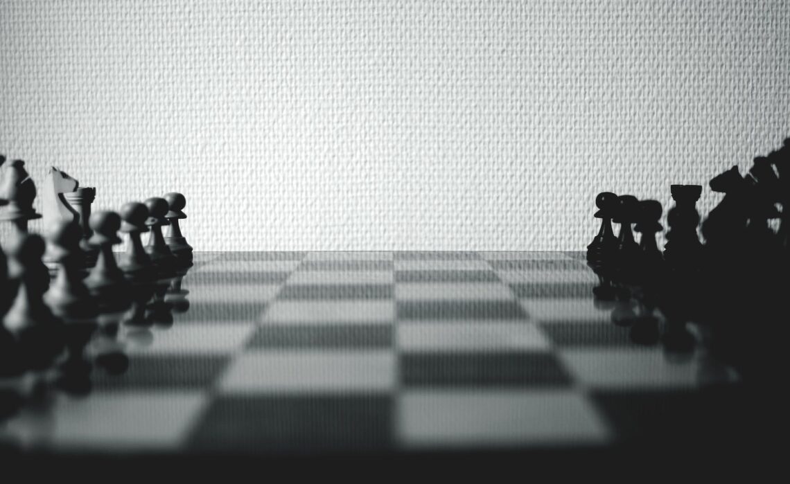 black and white chessboard set near white wall