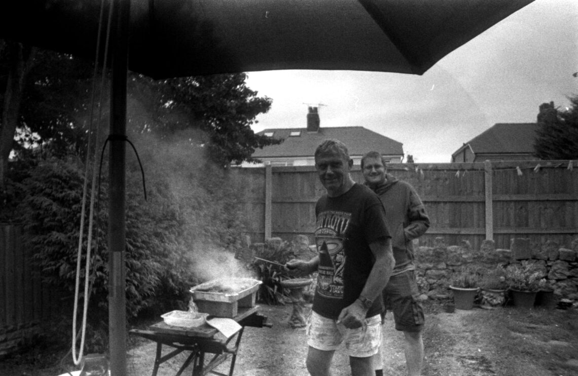 men having a barbecue in the backyard